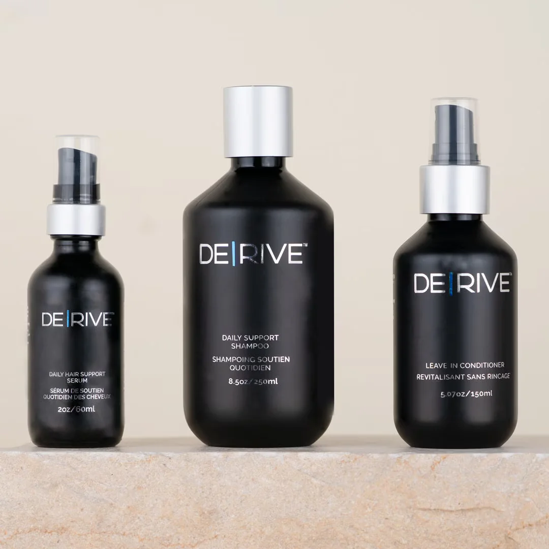 DE|RIVE product line — Daily Hair Support Serum, Daily Support Shampoo, and Leave-In Conditioner