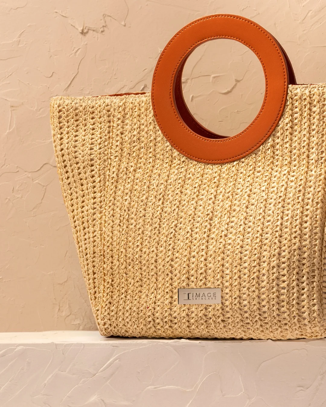 The end of summer tote, a woven bag with round leather handles